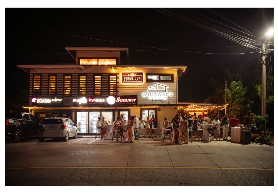 Windward Terraces flagship property — illuminated evening exterior in West Bay, Roatán